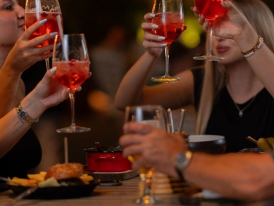 Guests raising glasses at the table