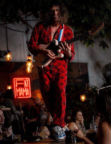 A musician performing above the dining room